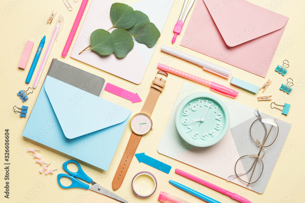 Set of school supplies with clock on color background