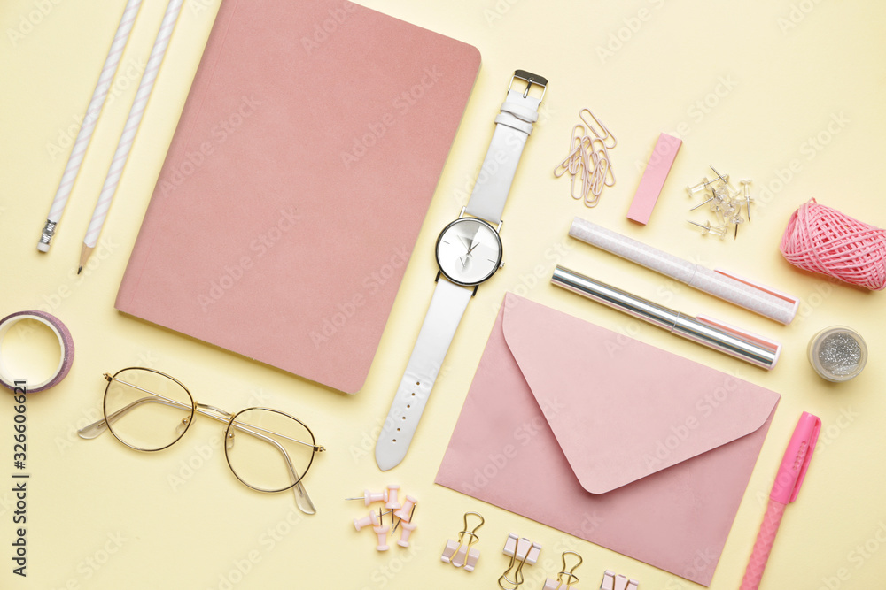 Set of school supplies with clock on color background