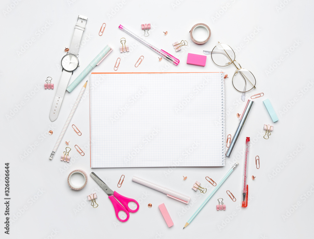 Notebook with school supplies on white background