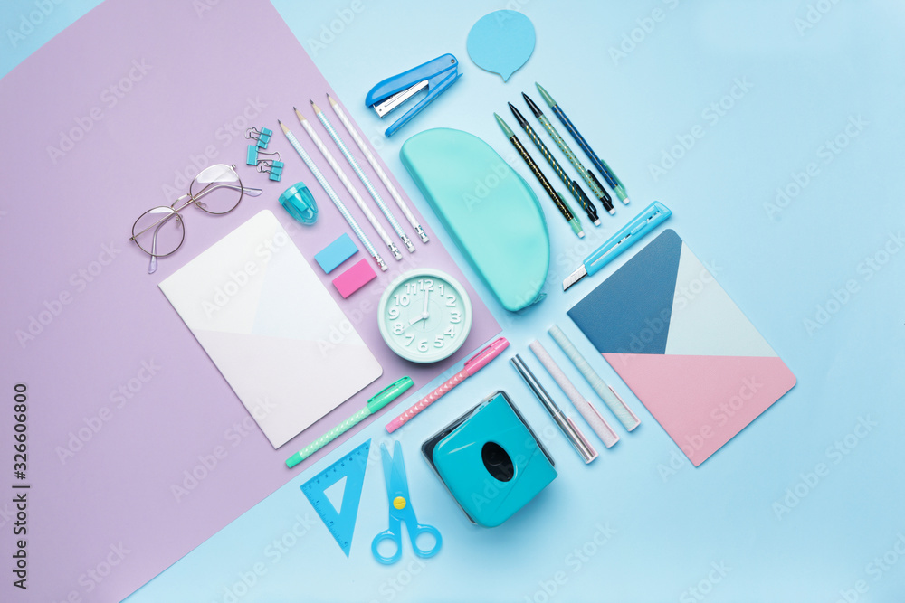 Set of school supplies with clock on color background