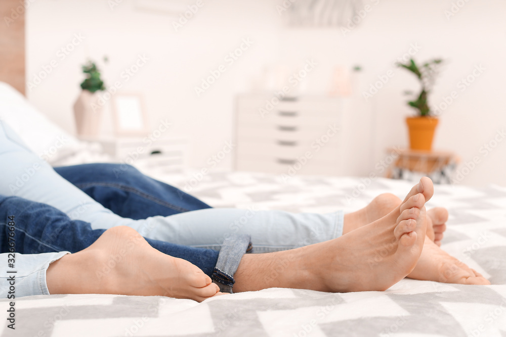 Young couple lying on bed at home