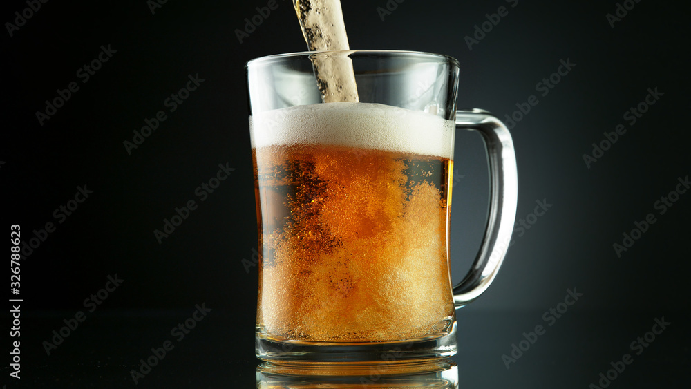 Freeze motion of pouring beer into glass pint