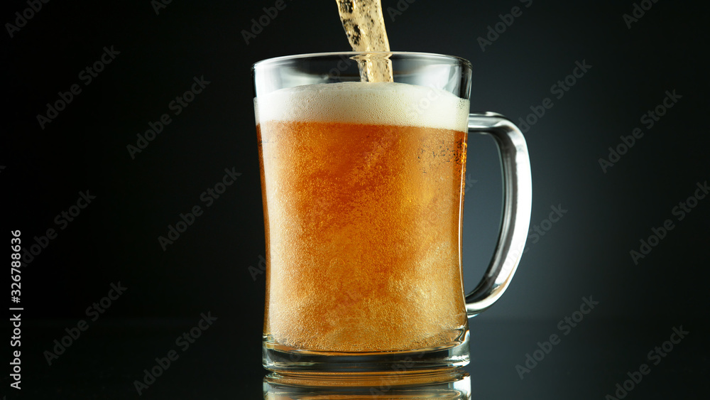 Freeze motion of pouring beer into glass pint