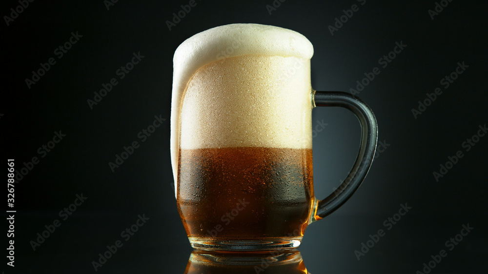 Beer foam overflowing from glass pint