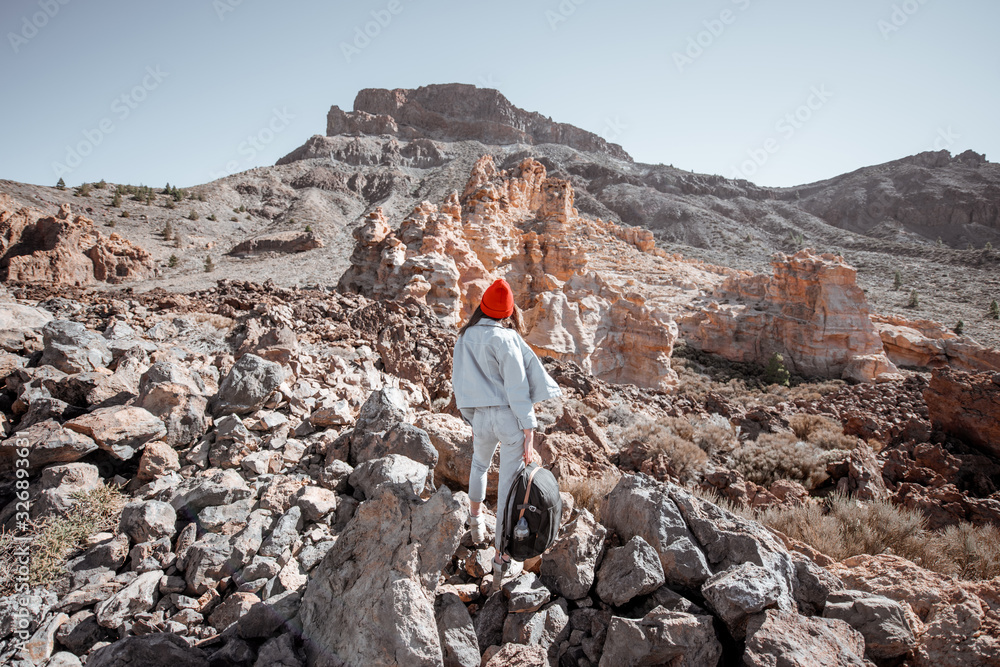 Young traveler dressed casually enjoying beautiful rocky landscapes while travel on the desert valle