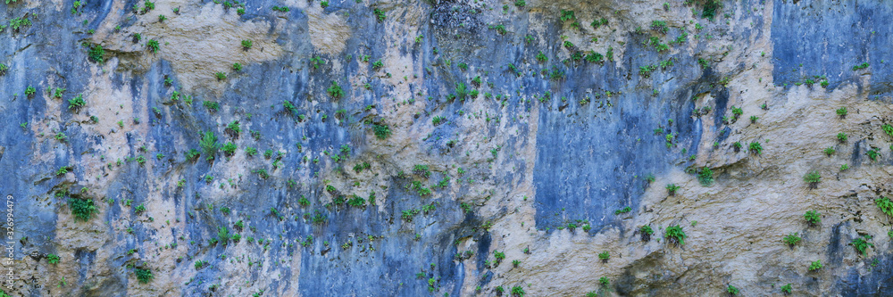 Texture of stone wall in wild nature on the rock edge