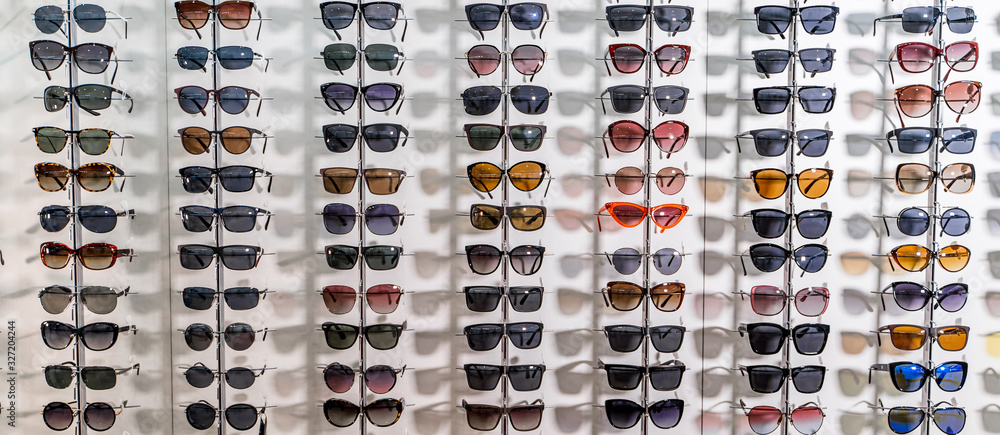 Sunglasses in a store. Showcase with spectacles in modern ophthalmic store.