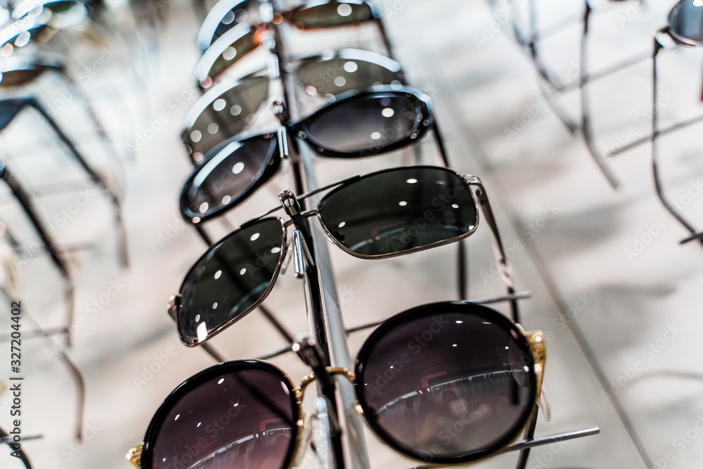 Sunglasses in a store. Row of luxury eyeglass at an opticians store