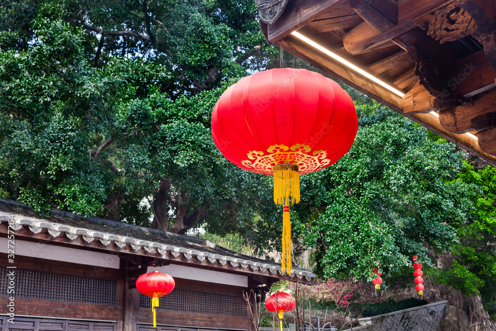 Beautiful red Chinese lantern hanging on eaves of  traditional Chinese old style Chinese wood  build