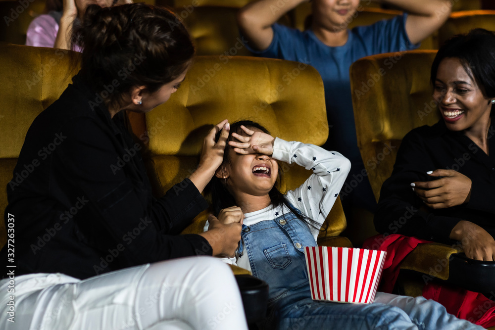 The girls cried loudly in the cinema, causing annoyance to the people sitting next to and behind the