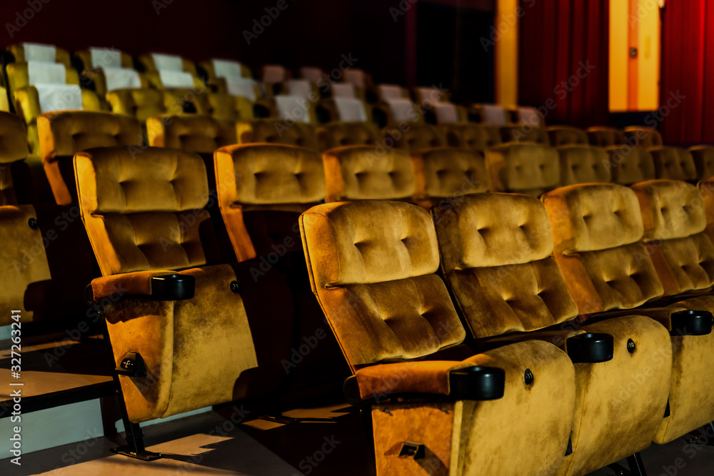 A row of yellow seat with popcorn on chair in the movie theater