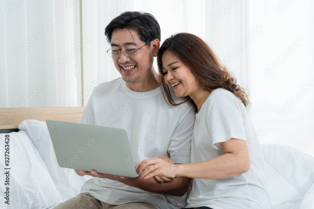 Happy Asian senior couple having good time at home. Old people retirement and healthy citizens elder