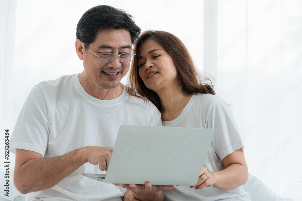 Happy Asian senior couple having good time at home. Old people retirement and healthy citizens elder