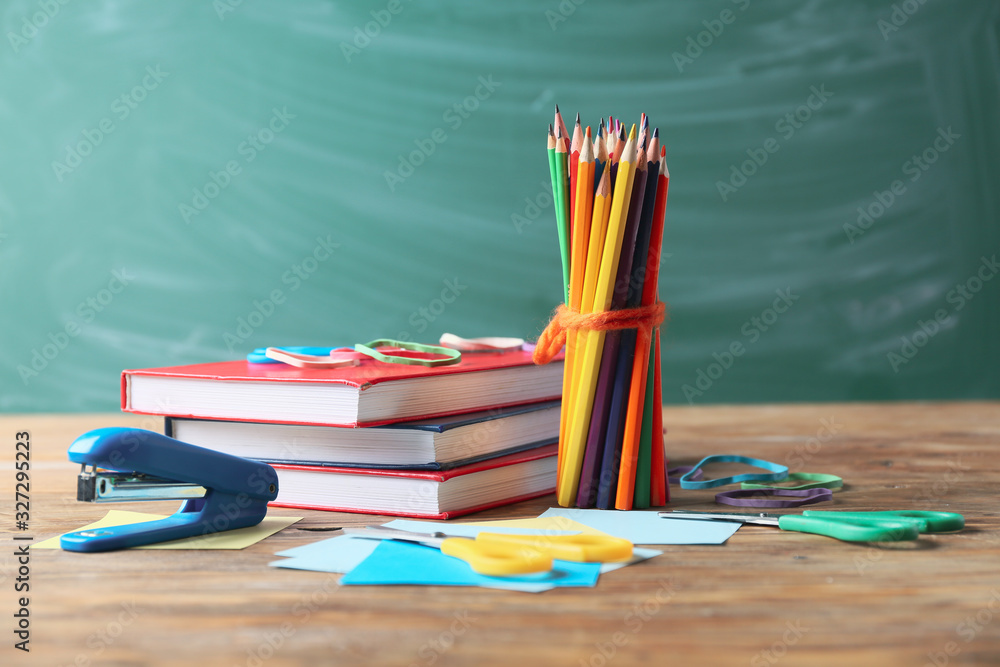 Set of school stationery on table in classroom