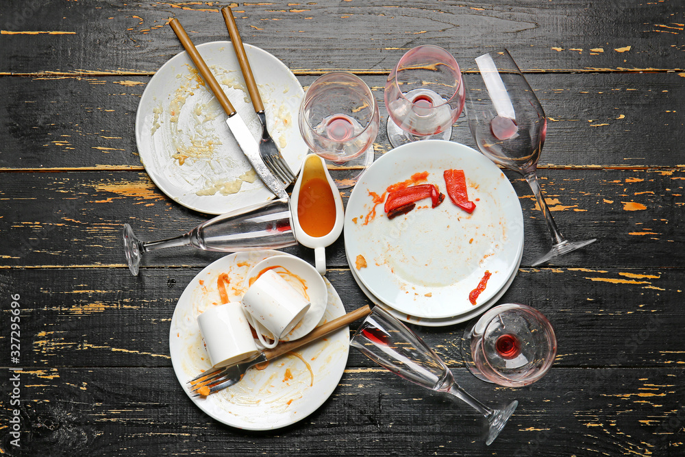 Dirty tableware on dark wooden background