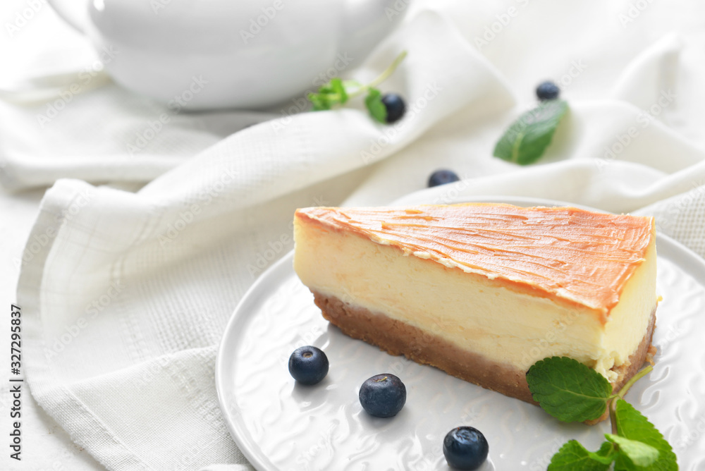 Slice of sweet caramel cheesecake on table