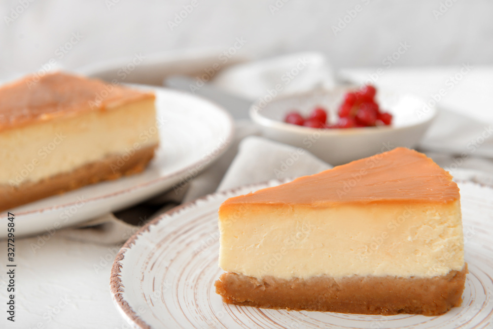 Slice of sweet caramel cheesecake on plate