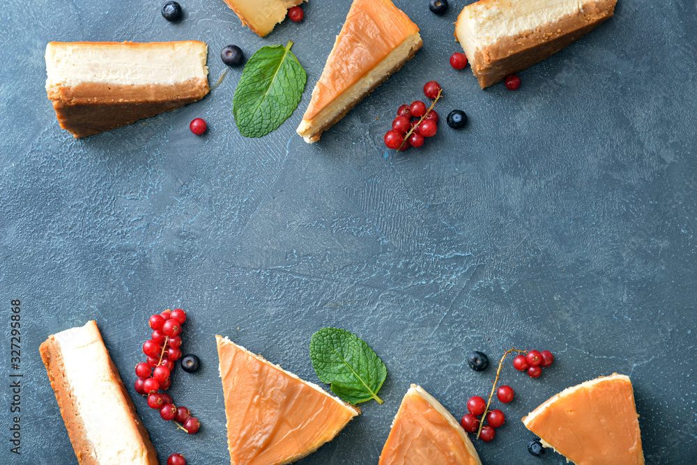 Slices of sweet caramel cheesecake with berries on dark background