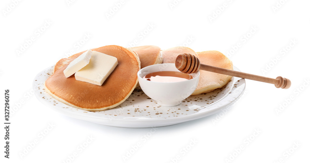 Tasty pancakes with honey and butter on white background