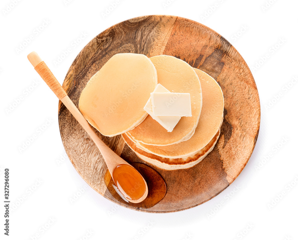 Tasty pancakes with honey and butter on white background