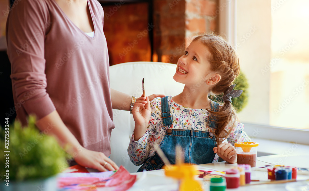 mother and child daughter painting draws in creativity in kindergarten.