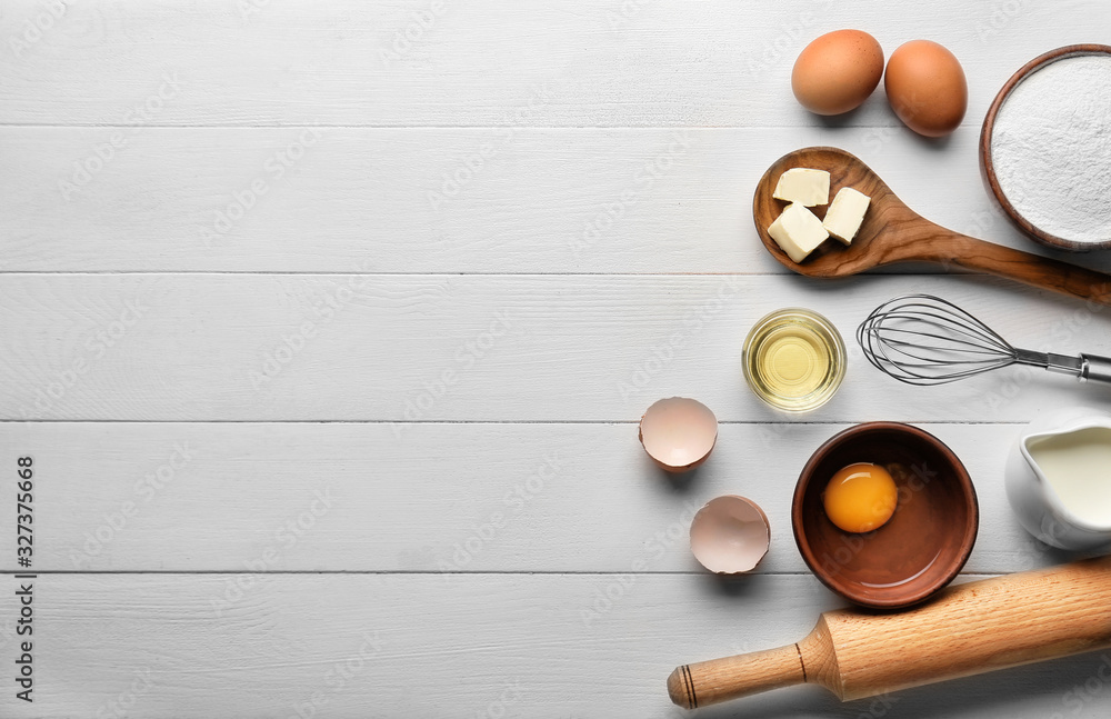 Ingredients for preparing bakery on white wooden table