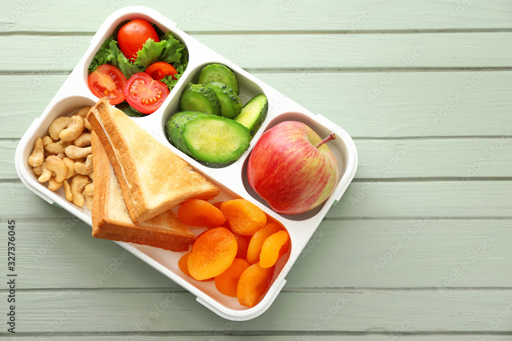 School lunch box with tasty food on table