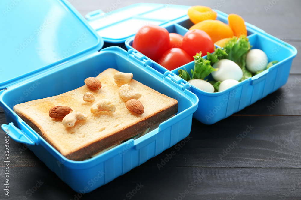 School lunch box with tasty food on table