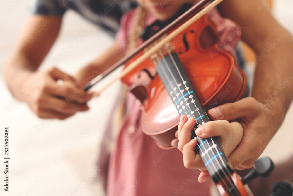 Teacher giving music lessons at school