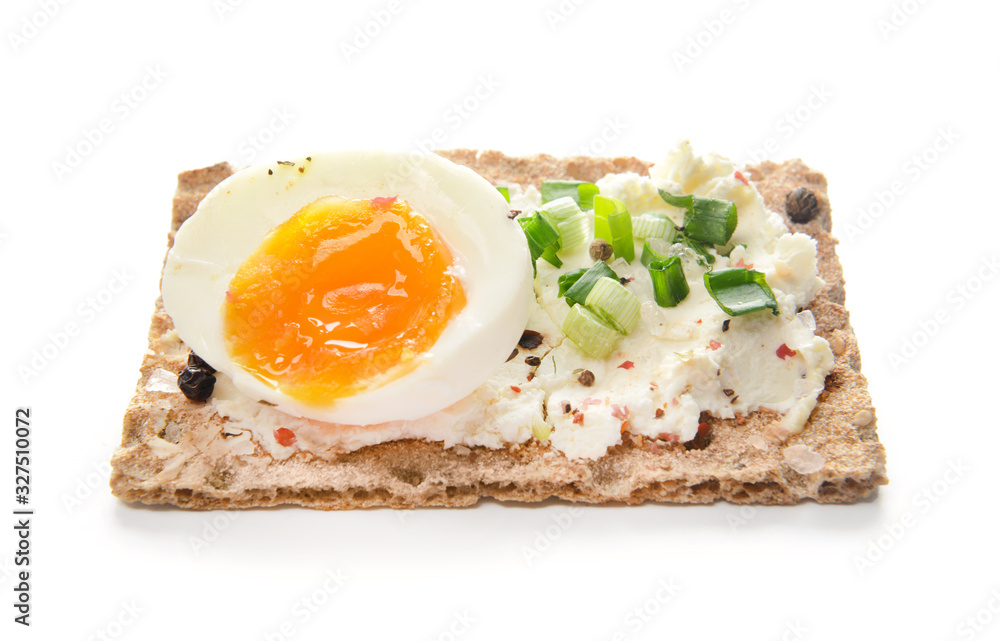 Crispbread with tasty cream cheese and egg on white background