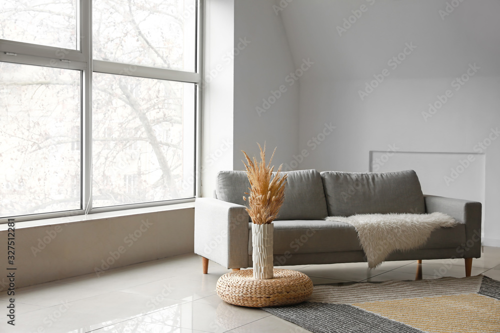 Interior of light room with sofa