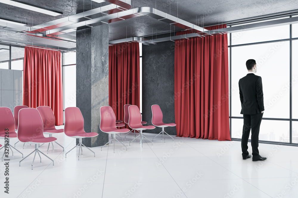 Businessman standing in contemporary presentation room