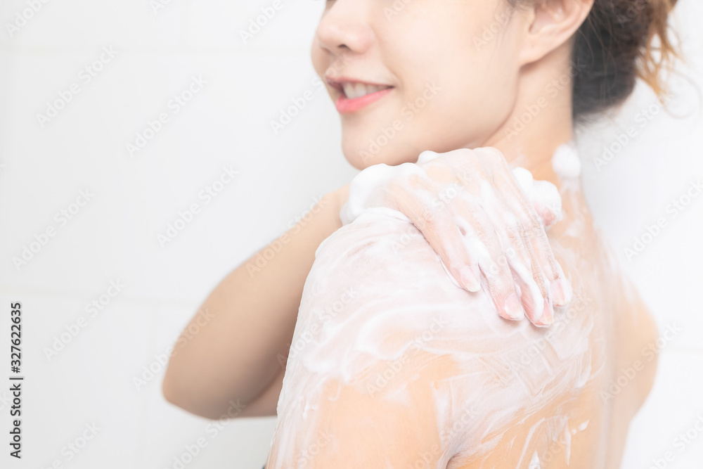 Happy asian women taking shower with foam bath.