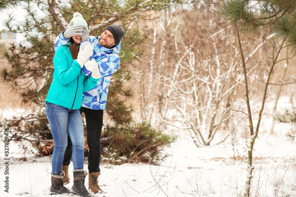 Happy young couple in park on winter day