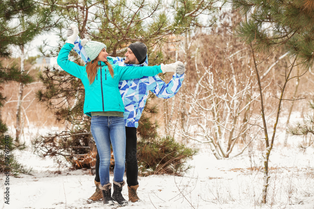 Happy young couple in park on winter day