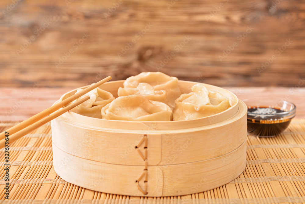 Steamer with oriental dumplings on table