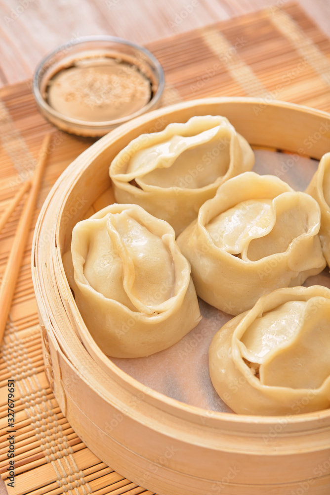 Steamer with oriental dumplings on table