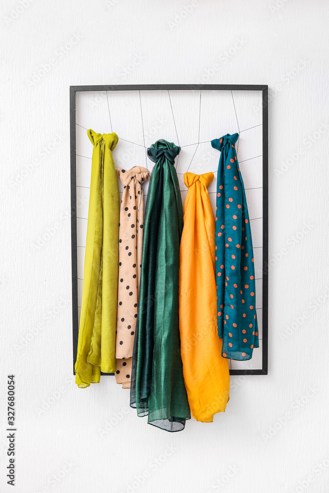 Frame with different beautiful scarves on white background