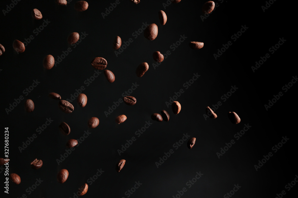 Falling coffee beans on dark background