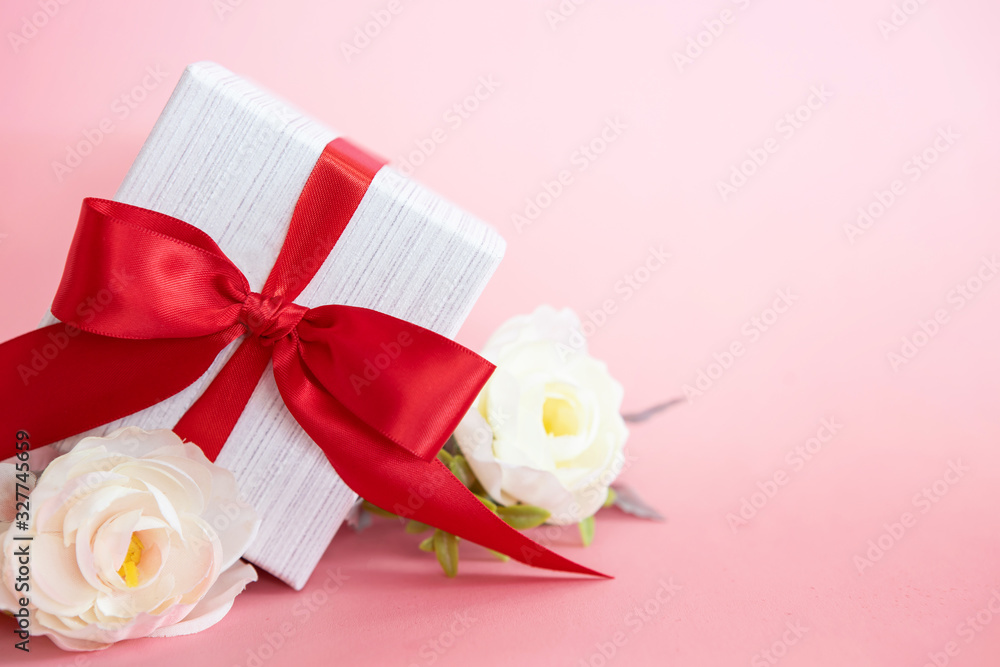  gift box with red bow on a pink background . valentine s or Mothers or Women s  day celebration 