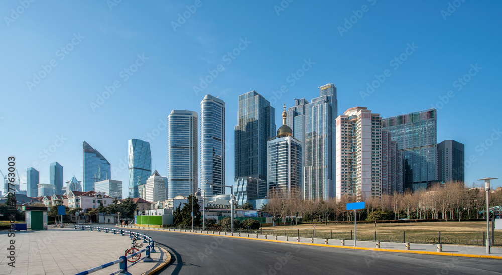 Qingdao urban skyline and asphalt road architectural landscape..