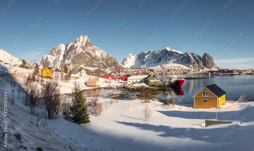 Lofoten islands with colorful fishing village and mountain range on coastline in winter at Norway