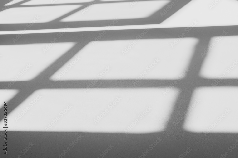 abstract shadow of the window in morning light on white wall texture background