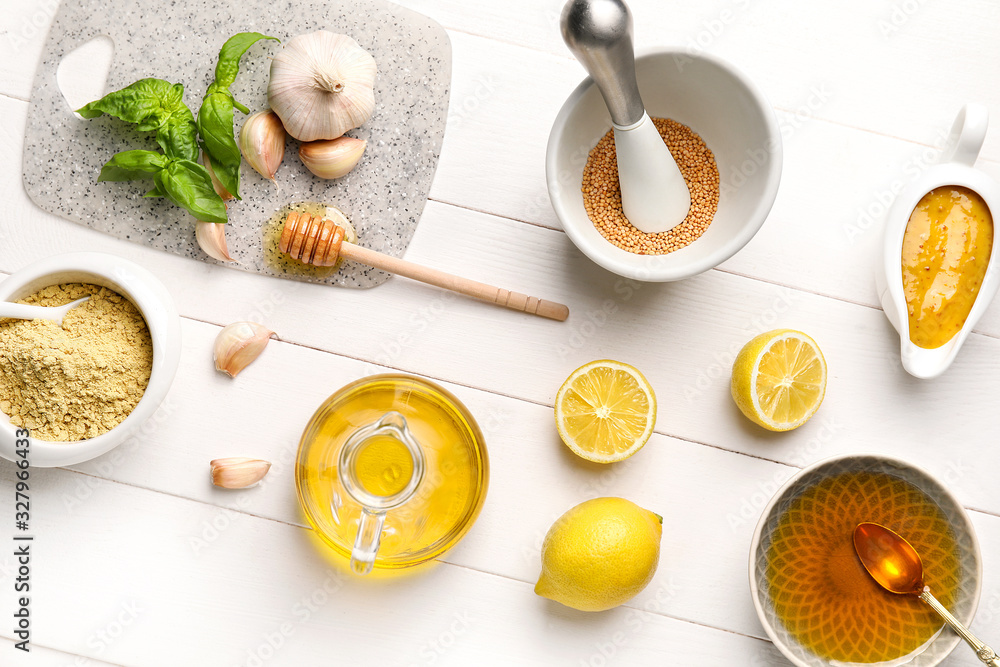 Ingredients for honey mustard sauce on white wooden background