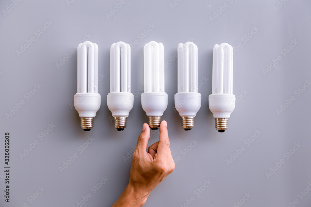 Businessman holding light bulbs, new ideas with innovative technology and creativity.