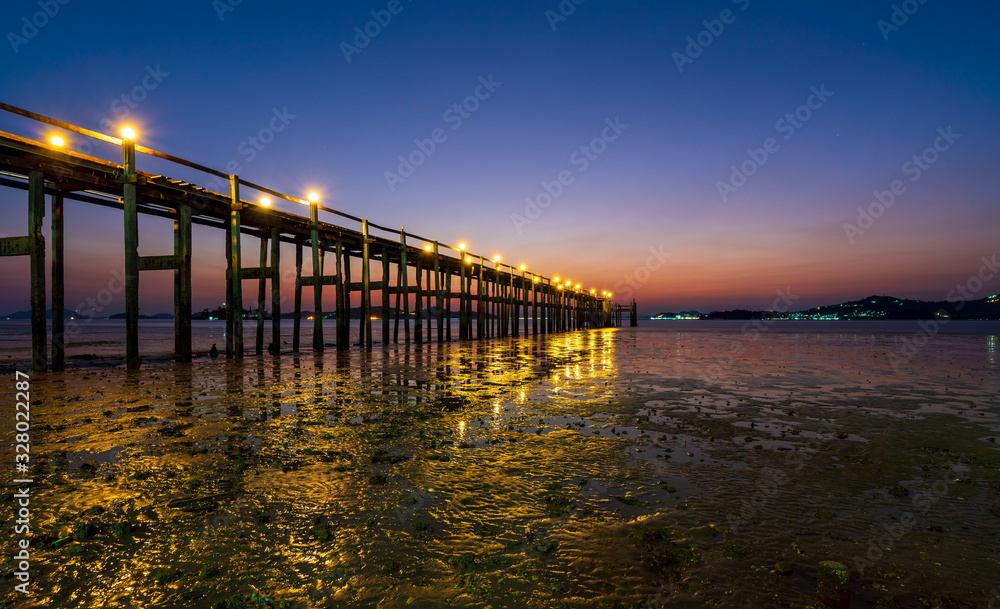 Wooden bridge of Chan Damri Beach at sunset ,Ranong ,Thailand