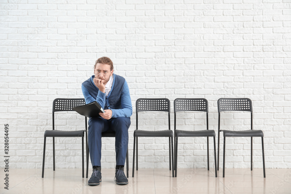 Young man waiting for job interview indoors