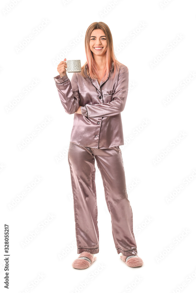 Portrait of woman in pajamas and with cup of coffee on white background