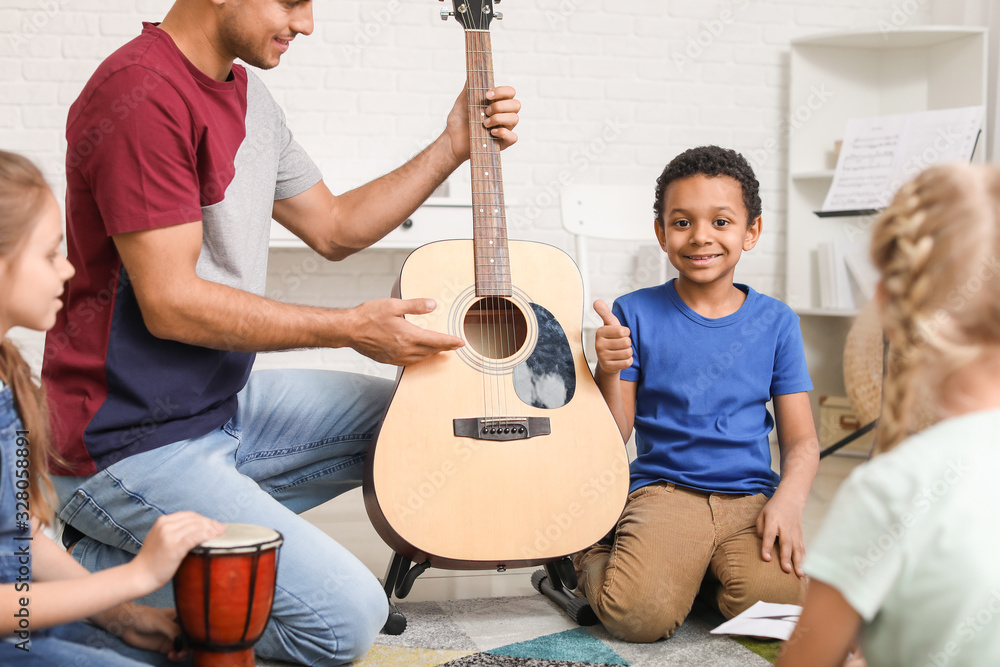 Teacher giving music lessons at school