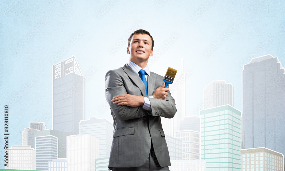 Creative businessman painter holding paintbrush